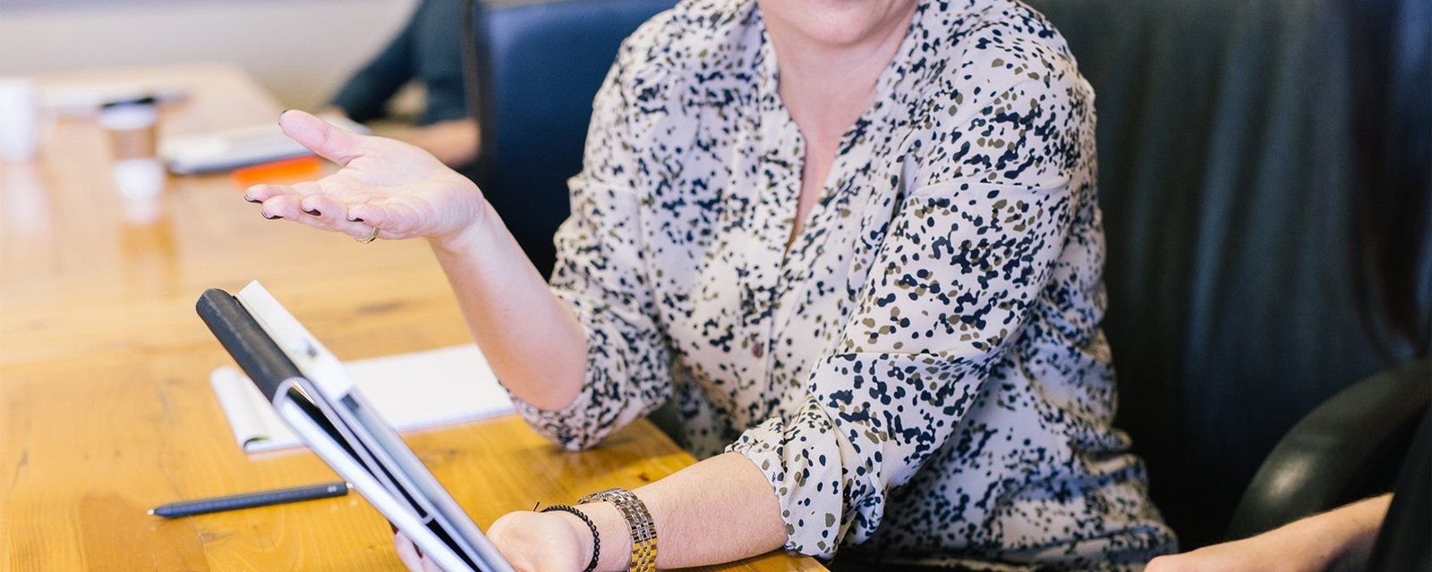 woman holding tablet computer showing to interviewer